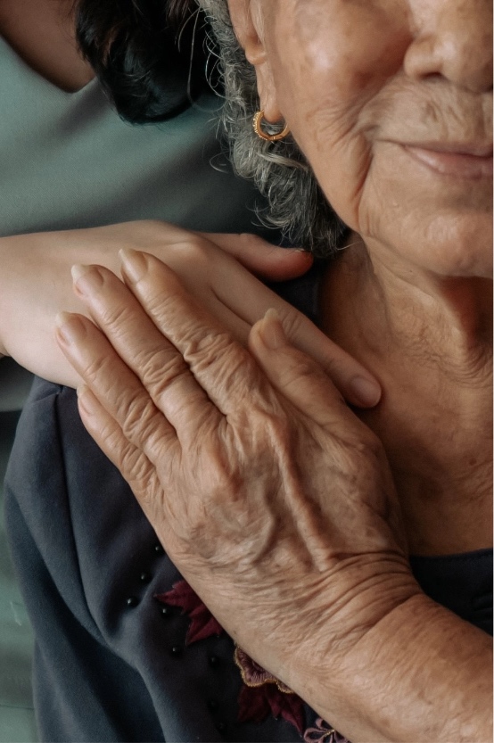 Woman with her hand on someone's shoulder